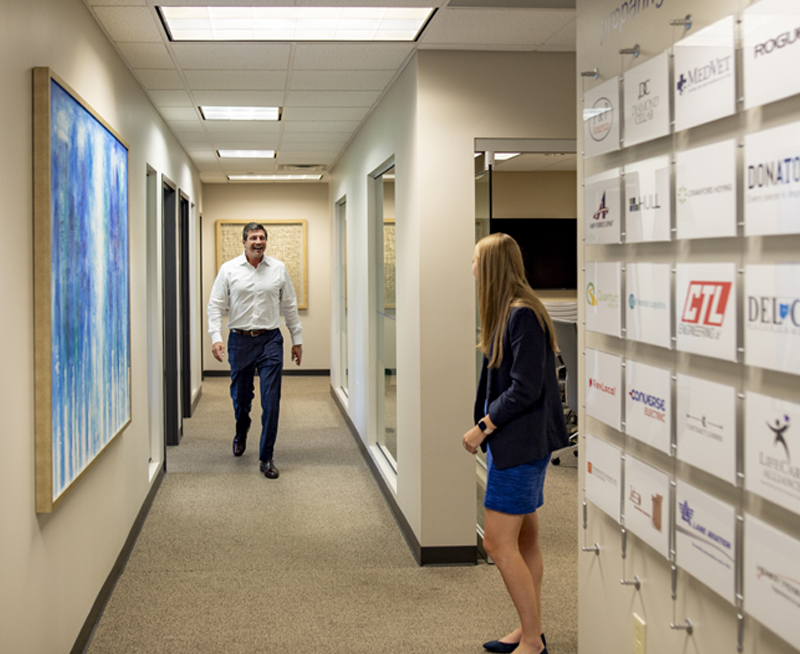 Scott Everhart walking in the Everhart Advisors office.